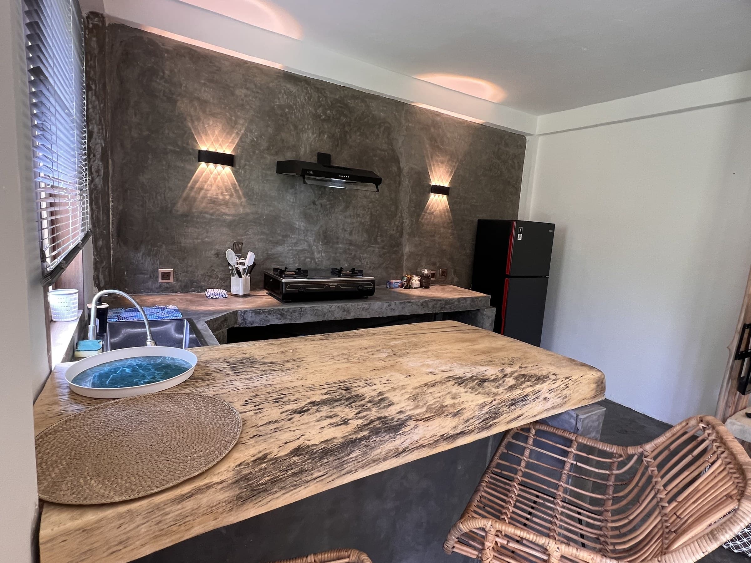 The studio’s kitchen, poured concrete and a breakfast bar