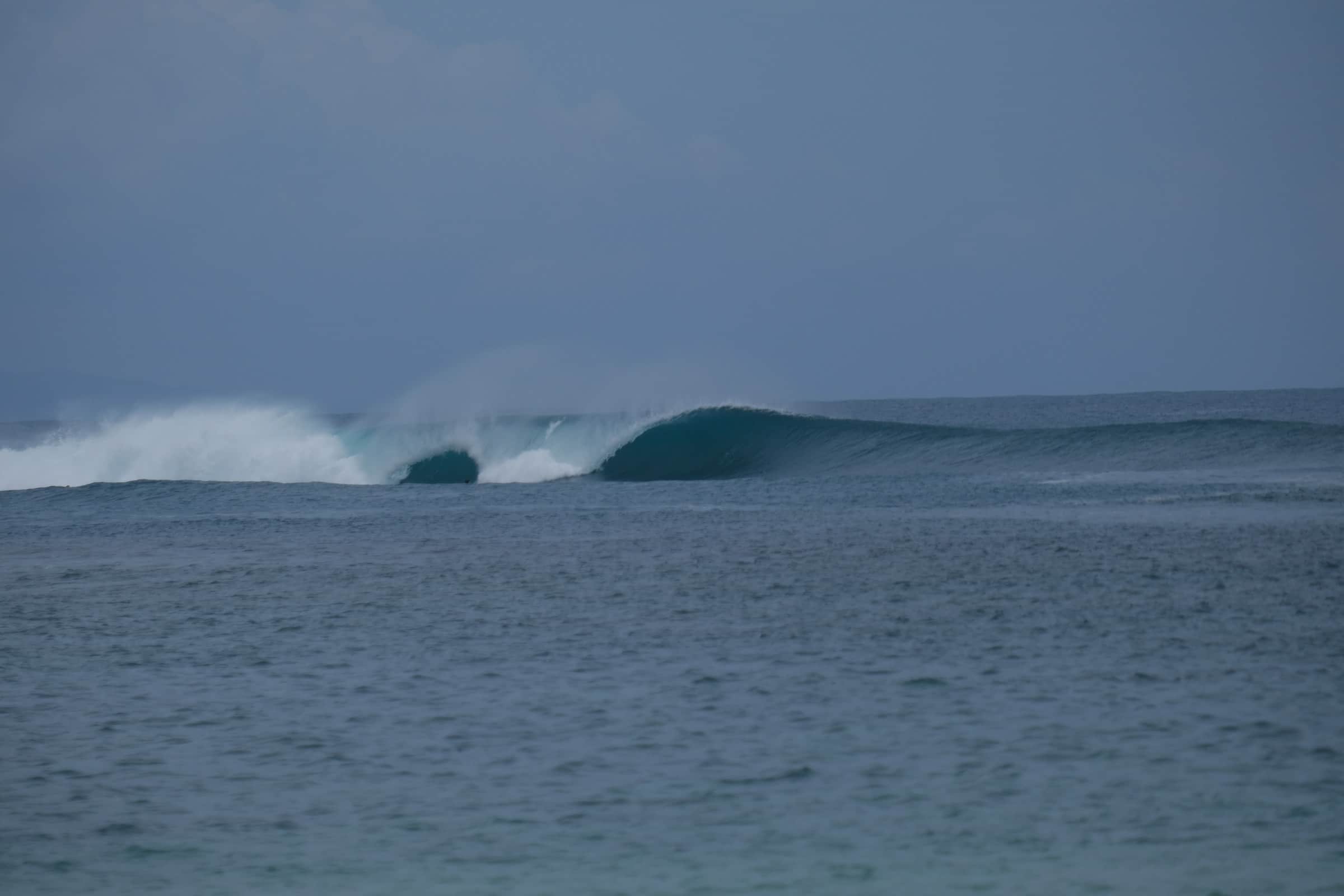 An empty wave running down the reef in front of the house
